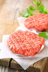 Raw minced meat for home made grill burgers cooking with spaces and herbs.