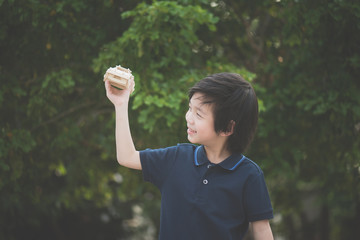 Cute Asian child playing wooden model car