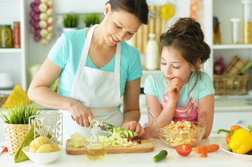 Mom and daughter cook