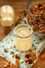 Yogurt in glass jars and granola in the background