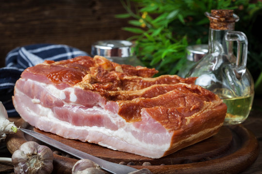 Raw bacon on a chopping board.