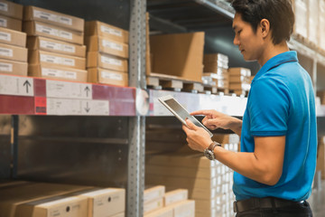 Portrait Of Manager In Warehouse. wholesale, logistic, people and export concept . Business owner Using Tablet Computer In Distribution Warehouse.