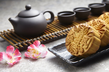 Golden Emerald mooncake on wooden table. Chinese mid autumn festival foods