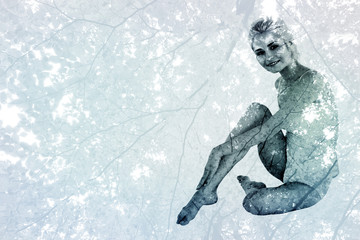 Full length portrait of a toned blond against branches and autumnal leaves