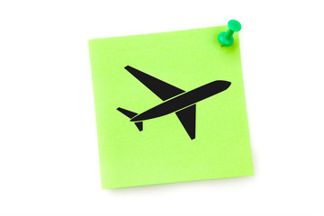 Airplane against green adhesive note