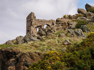 leftovers of a stone ruin on rocks in a mountain landscape