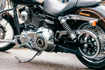 Closeup of motorbike with lots of chrome details. Modern powerful perfomance road motorcycle shiny reflexive surface engine with exhaust pipes.  Vehicle industry.  Two-wheeled vehicle technologies.