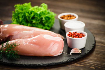 Raw chicken fillets and vegetables