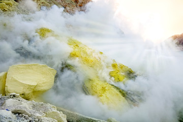 Sulfur rock in the crater of the Ijen volcano. The island of Java. Indonesia. Chemical natural background.