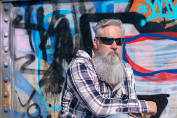 Mature man with long grey beard wearing sunglasses