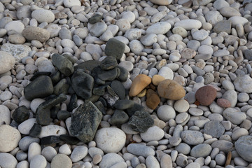 Pebble beach. Background of pebbles. Pebbles on the beach.
