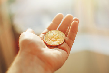 hand holding shiny golden bitcoin, gold money. digital currency, bit coin on people palm, cryptocurrency concept.space for text, money modern investment. luxury network currency