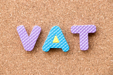 Fototapeta na wymiar Color toy foam alphabet in word VAT (Abberviation of Value added tax) on cork board background