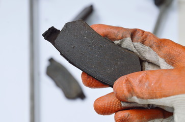 hand in glove holding invalid brake lining for changed