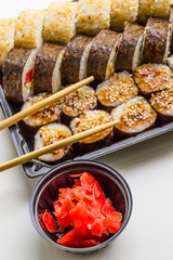 Sushi set: sushi roll with salmon and sushi roll with smoked eel, selective focus.