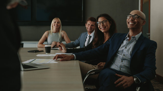 Diverse businesspeople smiling during a meeting