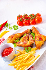 Grilled chicken wings,legs,chips and vegetables