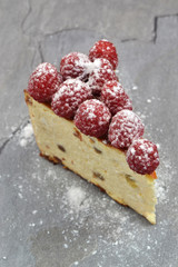 Rapberry cheesecake. A piece of delicious summer cake on gray kitchen countertop