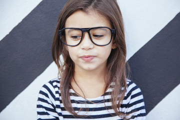 portrait of a cool girl against a striped wall