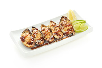 mussels on a white plate with lemon isolated on a white background