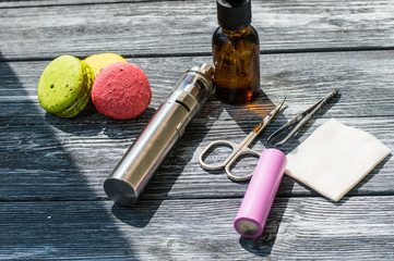 Still life with e-cig and jiuce on the wooden background