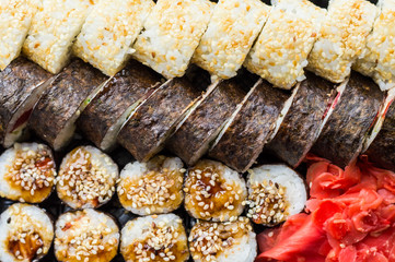Sushi set: sushi roll with salmon and sushi roll with smoked eel, selective focus.