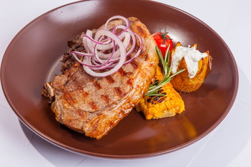 Steak on brown plate