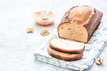Caramel baileys loaf cake on light concrete background. Selective focus, space for text.