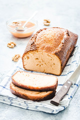 Brown sugar loaf cake on light concrete background. Selective focus, space for text.
