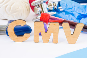 CMV abbreviation or acronym in foreground, in laboratory, scientific or medical practice meaning Cytomegalovirus, with model of brain, neurological hammer, laboratory test tubes,  stethoscope