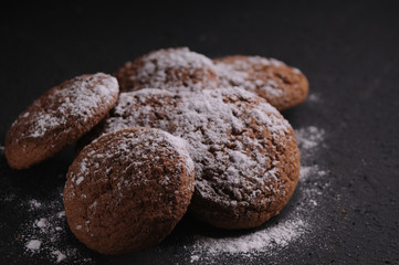 oatmeal cookies on a black table in castor sugar