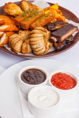 Grilled sausages on a plate with sauce