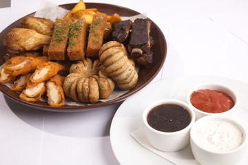 Grilled sausages on a plate with sauce