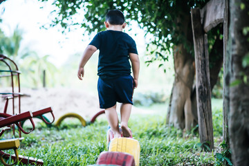  Kids  running on tires in the playground. © Johnstocker