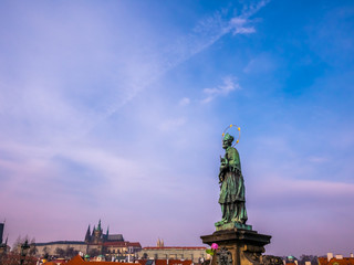 Fototapeta premium 17th Century Crucifixion statue with Hebrew lettering blue sky winter season in Charles Bridge Prague, Czech Republic .