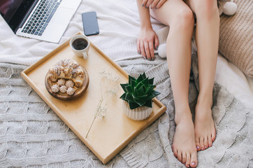 Breakfast in bed on a tray, fragrant coffee and croissants