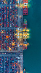 Container ship in export and import business and logistics. Shipping cargo to harbor by crane. Water transport International. Aerial view and top view.