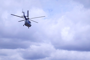 Fototapeta na wymiar White blue helicopter on the sky background. Model MI-8