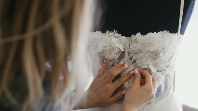 Fashion Designer for Brides in Her Studio Pins Needles Lace and Flowers Wdding Dress.