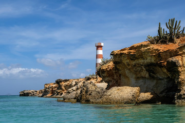 Tropical seascape with a light house along the  coast of Cubagua island (Venezuela).
