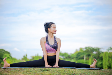 Exercise with yoga for health and relaxation,Asian woman.
