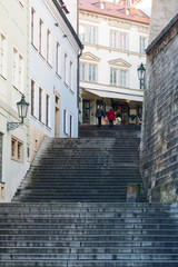Fototapeta na wymiar Stairs at the narrow street. Prague, Czech. Street photo