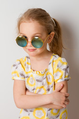 little girl in round sunglasses