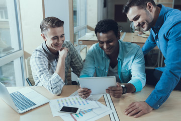 Multiethnic team of young successful creative people is working on common project. Startup.