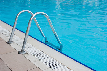 blue swimming pool with steel ladder