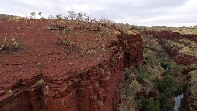 View of red desert cliffs in canyon gorge of Karijini NP in Western Australia.