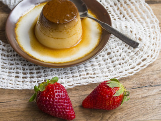  Flan in a plate on wood background