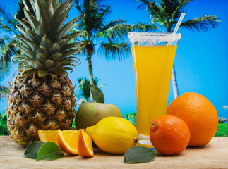 Glass of orange juice on a beach