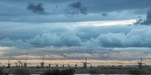 Windmills at grey and blue sunset sky - 203083842