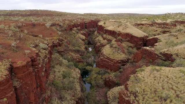 Aerial view flying over canyon gorge in Karijini National Park in Western Australia.